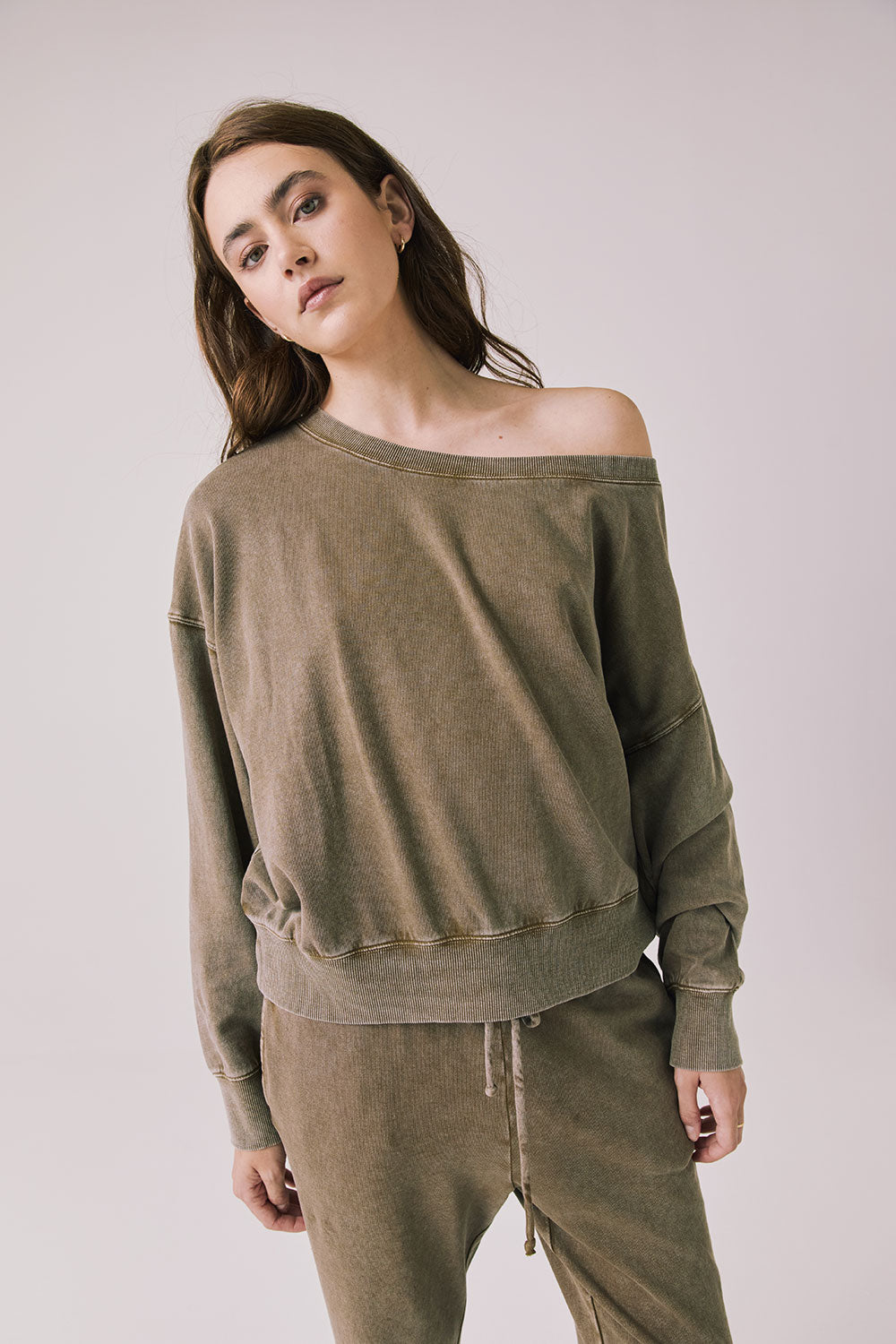 Woman wearing Chaser's Bellini Ginger Brown Pullover and matching pants on a white background