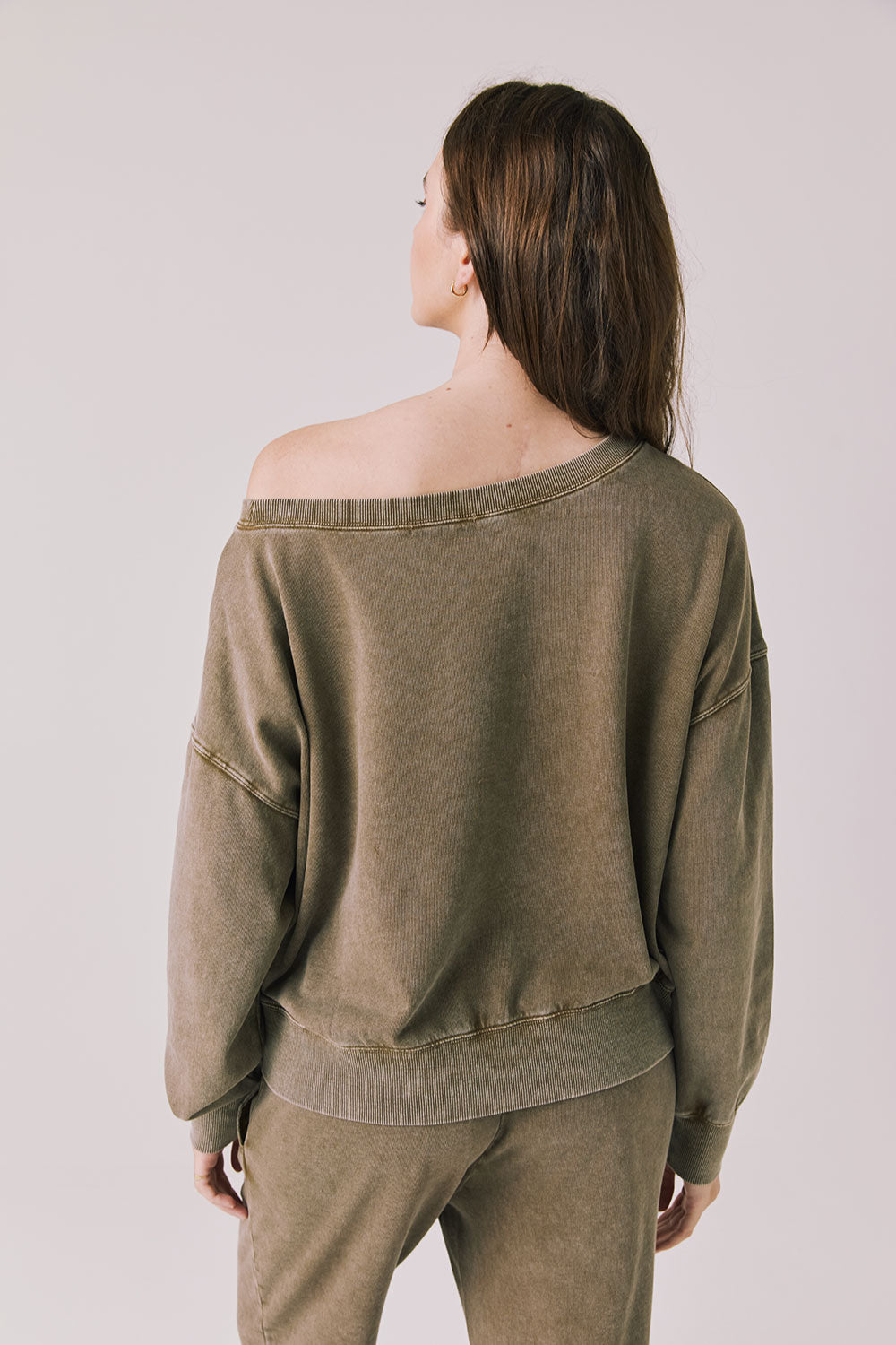 Back view of a woman wearing Chaser's Bellini Ginger Brown Pullover and matching pants on a white background