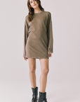 Full body view of woman wearing Chaser’s Ginger Brown Margarita Mini Dress with black boots on a plain background