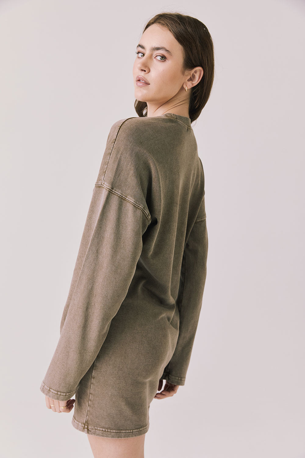 Back view of woman wearing Chaser’s Ginger Brown Margarita Mini Dress on a plain background