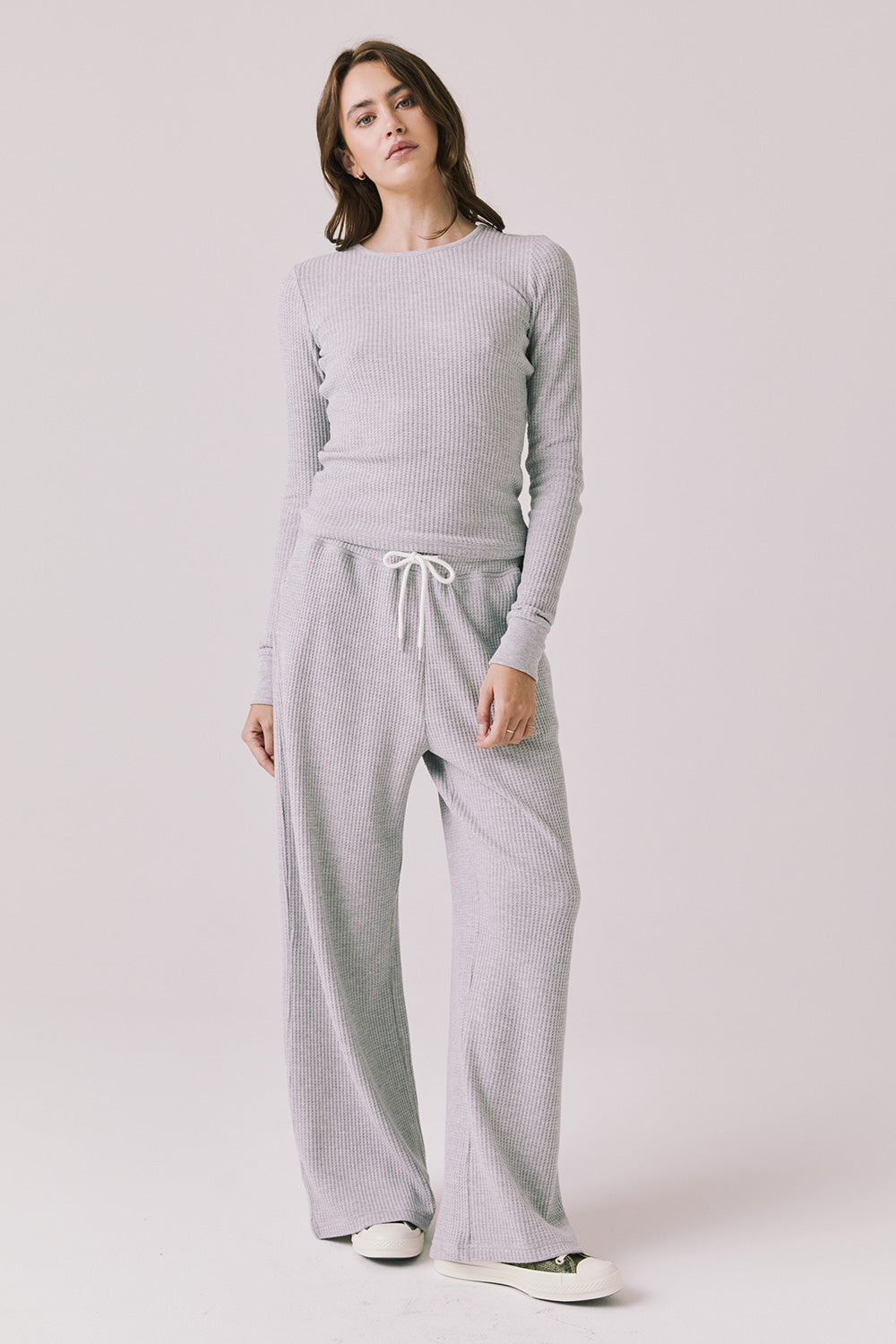 Full body view of woman wearing Chaser’s Spritz Long Sleeve with matching Brandy Light Heather Grey Joggers on a white background