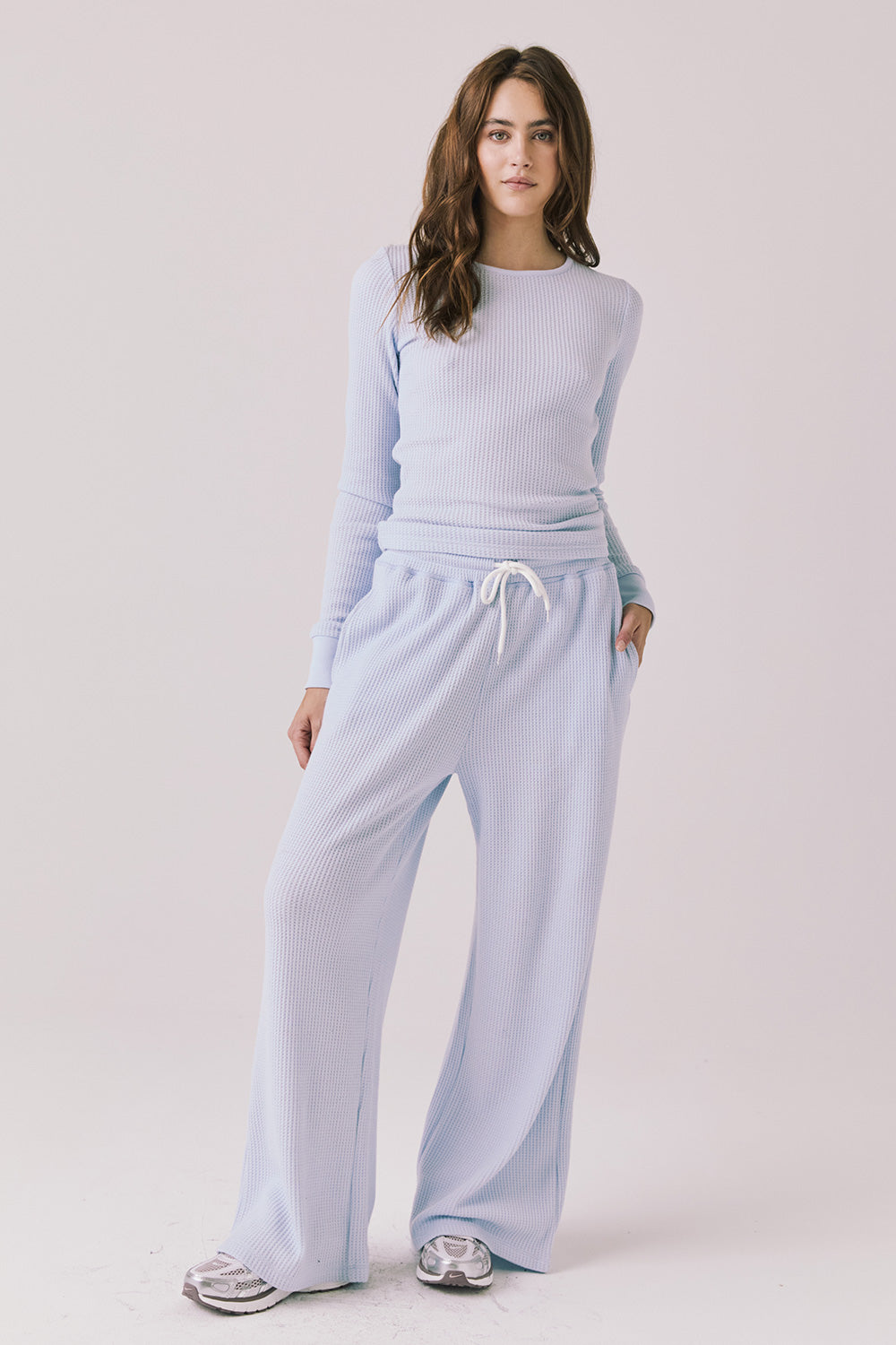 Full body view of woman wearing Chaser’s Spritz Long Sleeve with matching Brandy Skyway Blue Joggers on a white background