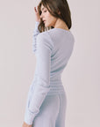 Back view of woman wearing Chaser’s Spritz Long Sleeve on a white background