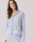 Woman wearing the Abilene Light Skyway Blue Zip Up Hoodie with matching pants on a white background