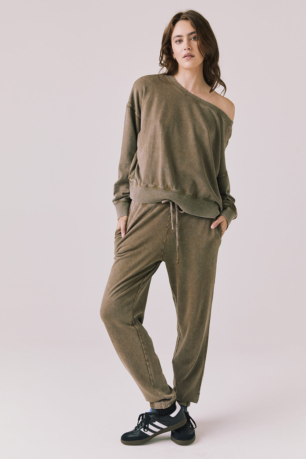 Full body view of woman wearing Chaser’s Ginger Brown Manhattan Joggers with matching Bellini Ginger Brown Pullover on a white background