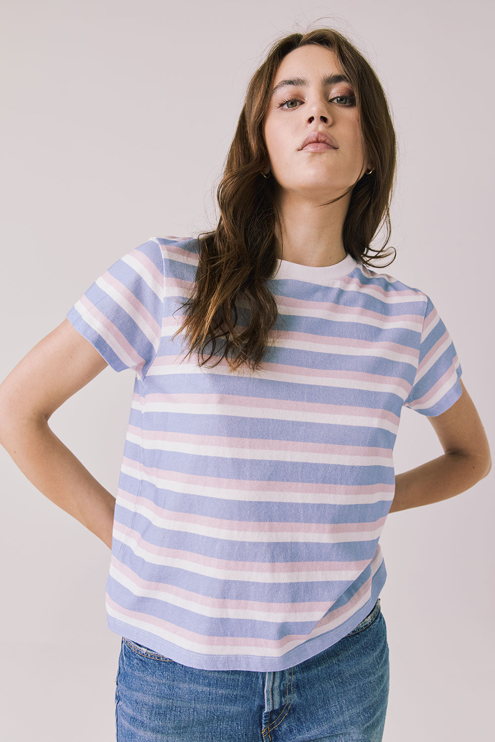Full body view of woman wearing Chaser’s Cosmo Pink Stripes Tee paired on a white background
