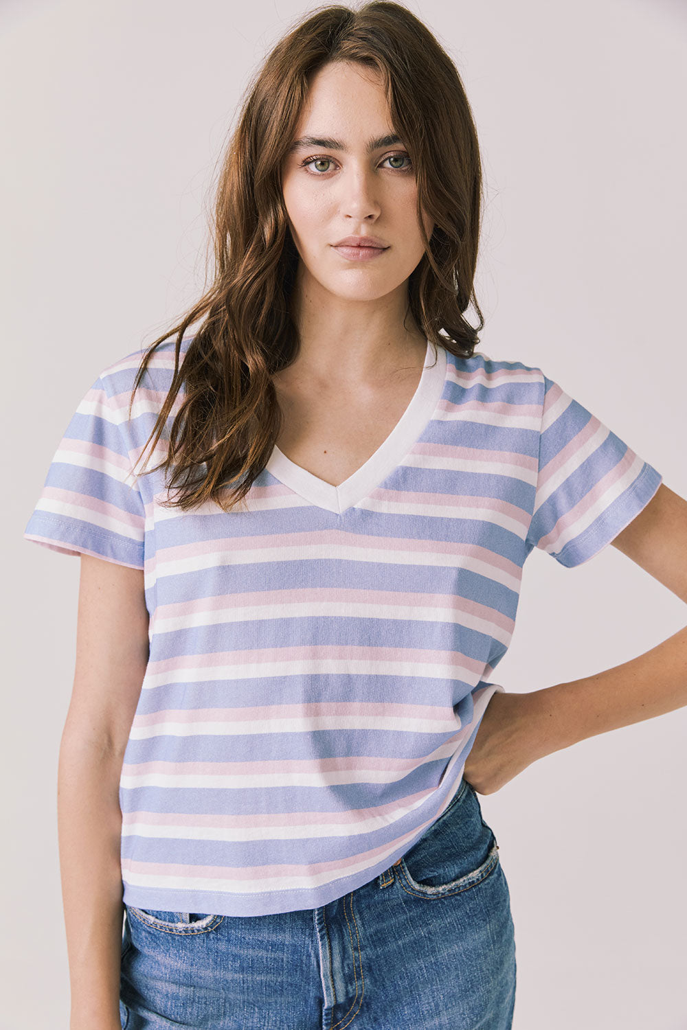 Front view of woman wearing Chaser’s Gimlet Pastel Stripe Tee on a plain background