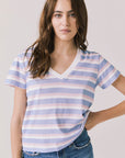 Front view of woman wearing Chaser’s Gimlet Pastel Stripe Tee on a plain background
