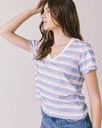 Side view of woman wearing Chaser’s Gimlet Pastel Stripe Tee on a plain background