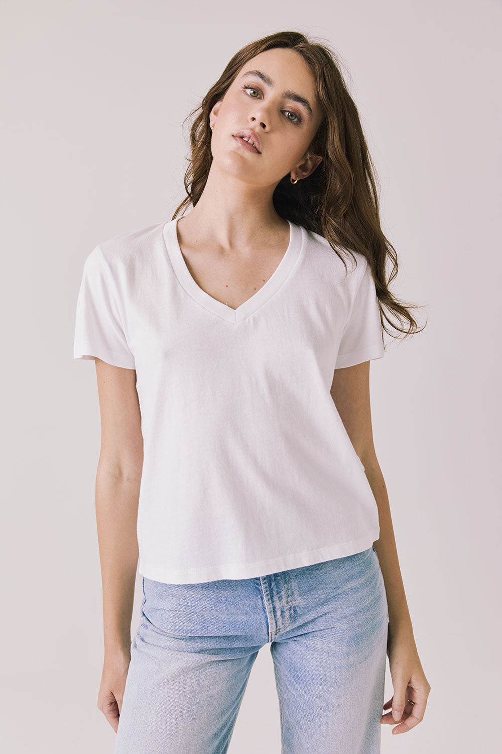 Front view of woman wearing Chaser’s Gimlet White Tee on a plain background