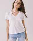 Front view of woman wearing Chaser’s Gimlet White Tee on a plain background