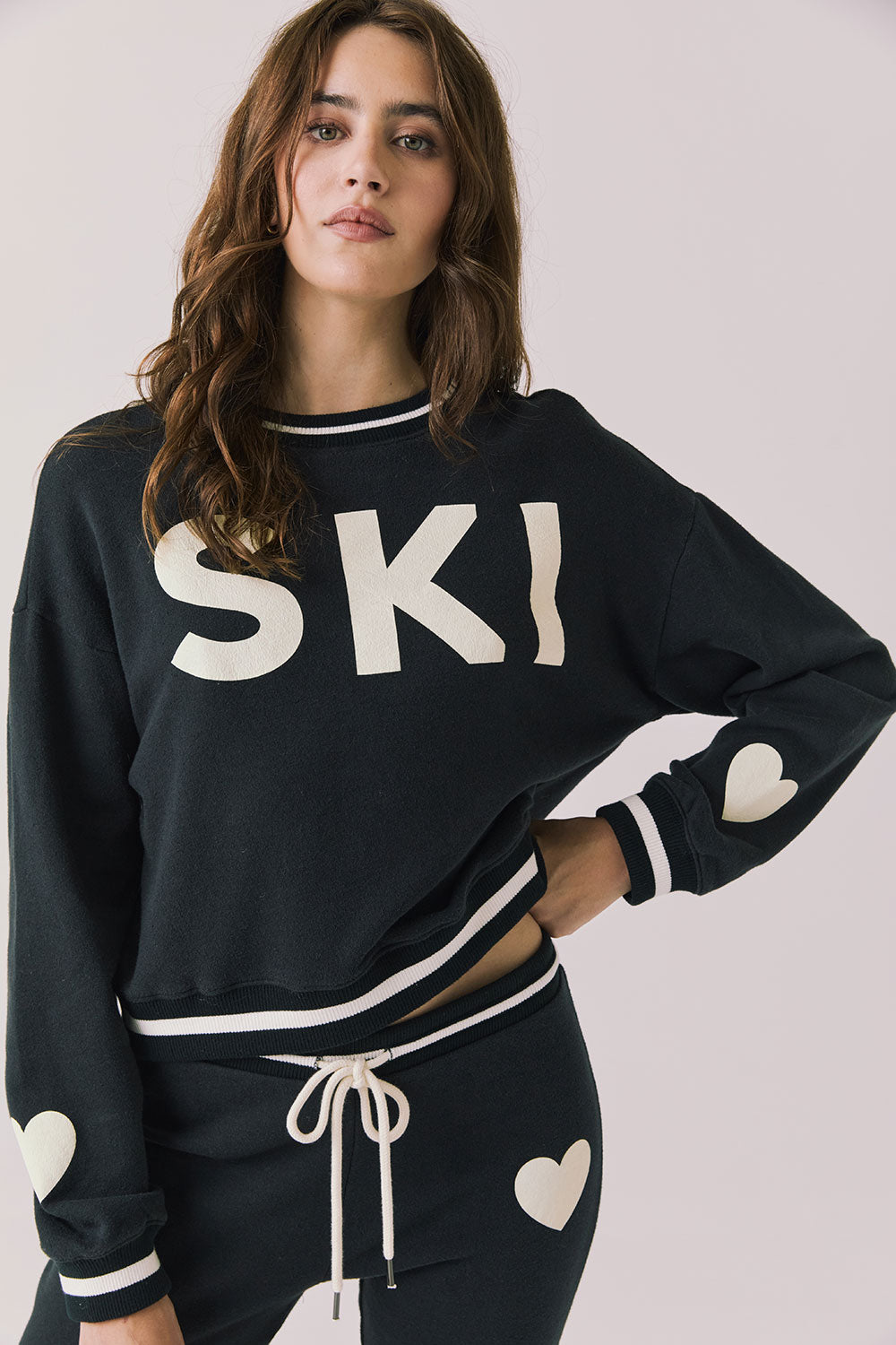 Front view of woman wearing Chaser’s Ski True Black Long Sleeve Pullover on a white background