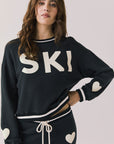 Front view of woman wearing Chaser’s Ski True Black Long Sleeve Pullover on a white background