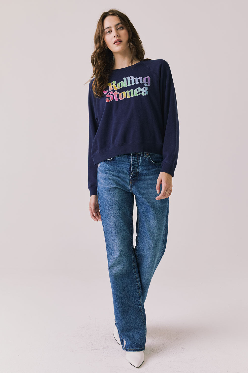 Full body view of woman wearing Chaser’s The Rolling Stones US Tour 1978 Long Sleeve in Oxford Blue with jeans on a white background