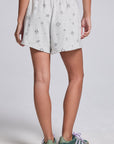 Model wearing Chaser's Twilight Shorts in Heather with scattered black stars and spark details, back view