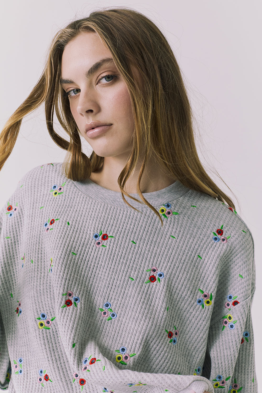 Chaser Terra Heather Grey Ditsy Embroidery Pullover close up showcasing multicolor ditsy floral embroidery on textured knit