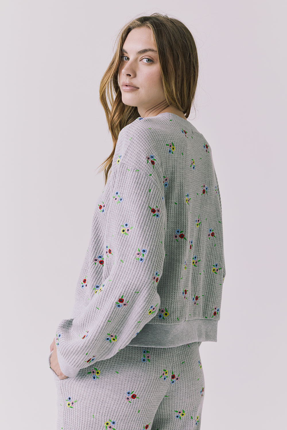 Chaser Terra Heather Grey Ditsy Embroidery Pullover shown over shoulder with relaxed back drape and ribbed trim