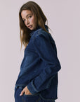 Chaser All Day Indigo Wash Button Down in Indigo Wash photographed from a soft side view highlighting the sleeve structure and smooth drape
