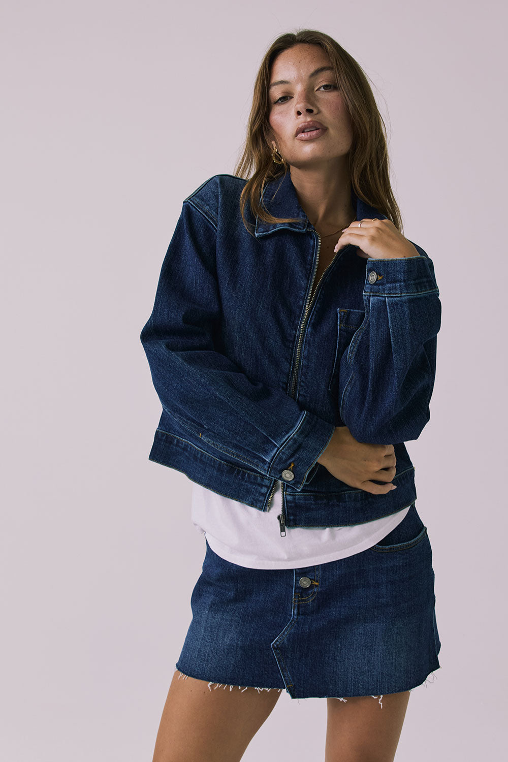 Full body view of the Chaser Sutton Indigo Wash Jacket worn open and styled with the matching Sloane Indigo Wash Mini Skirt