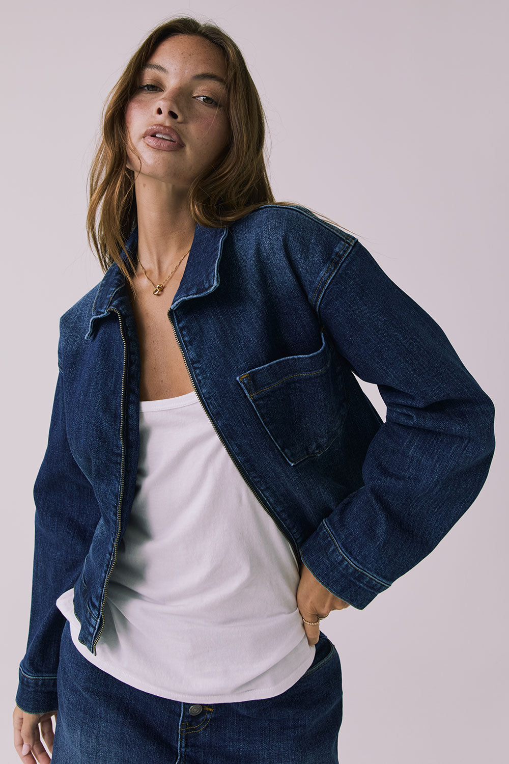 Mid-body view of the Chaser Sutton Indigo Wash Jacket showing zipper hardware and pocket stitching