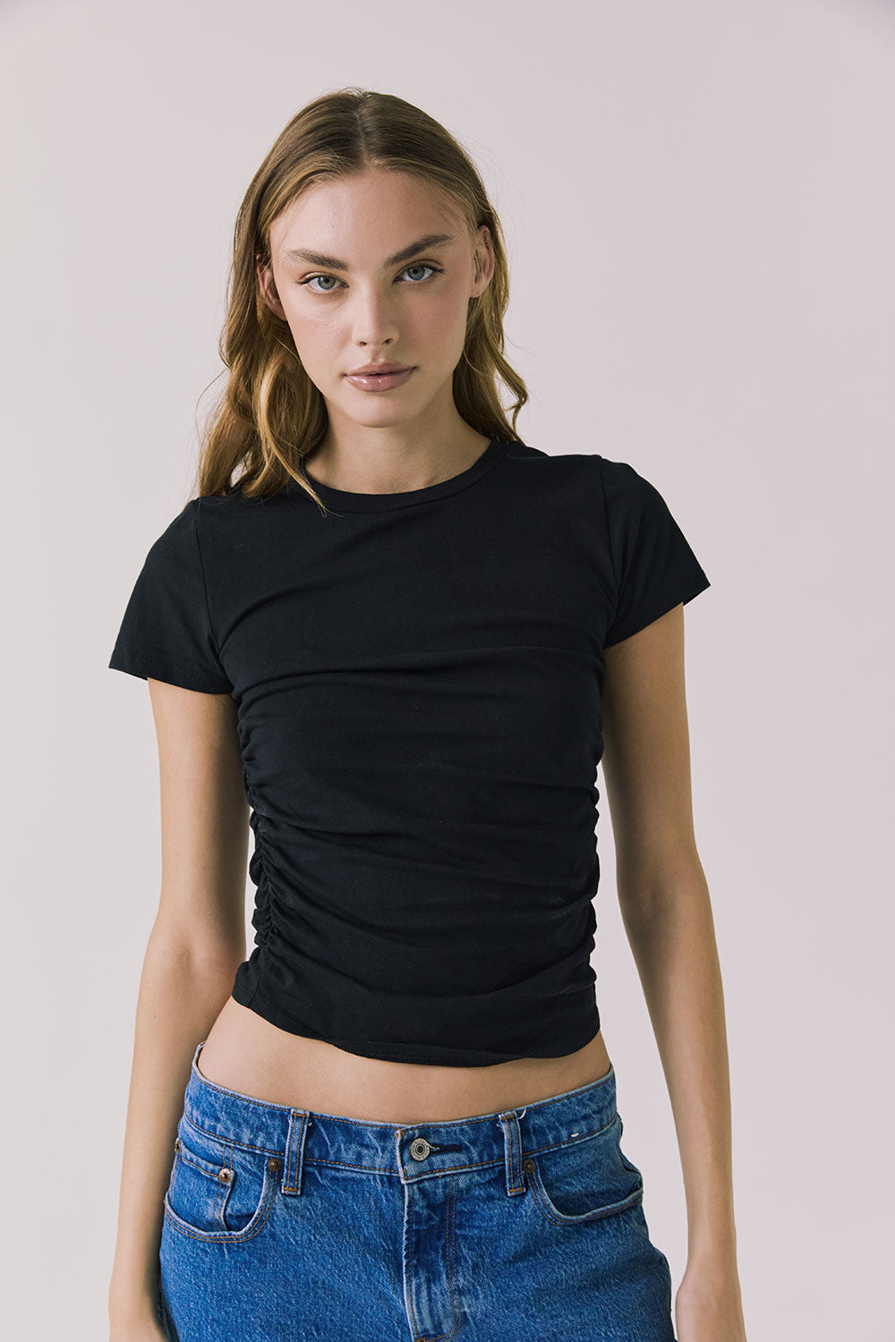 Front view of the Chaser Louis Black Tee featuring a fitted silhouette and soft side ruching