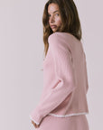 Back three-quarter view of Chaser Seaport Pink Salt cardigan showing relaxed fit and ribbed hem with matching joggers