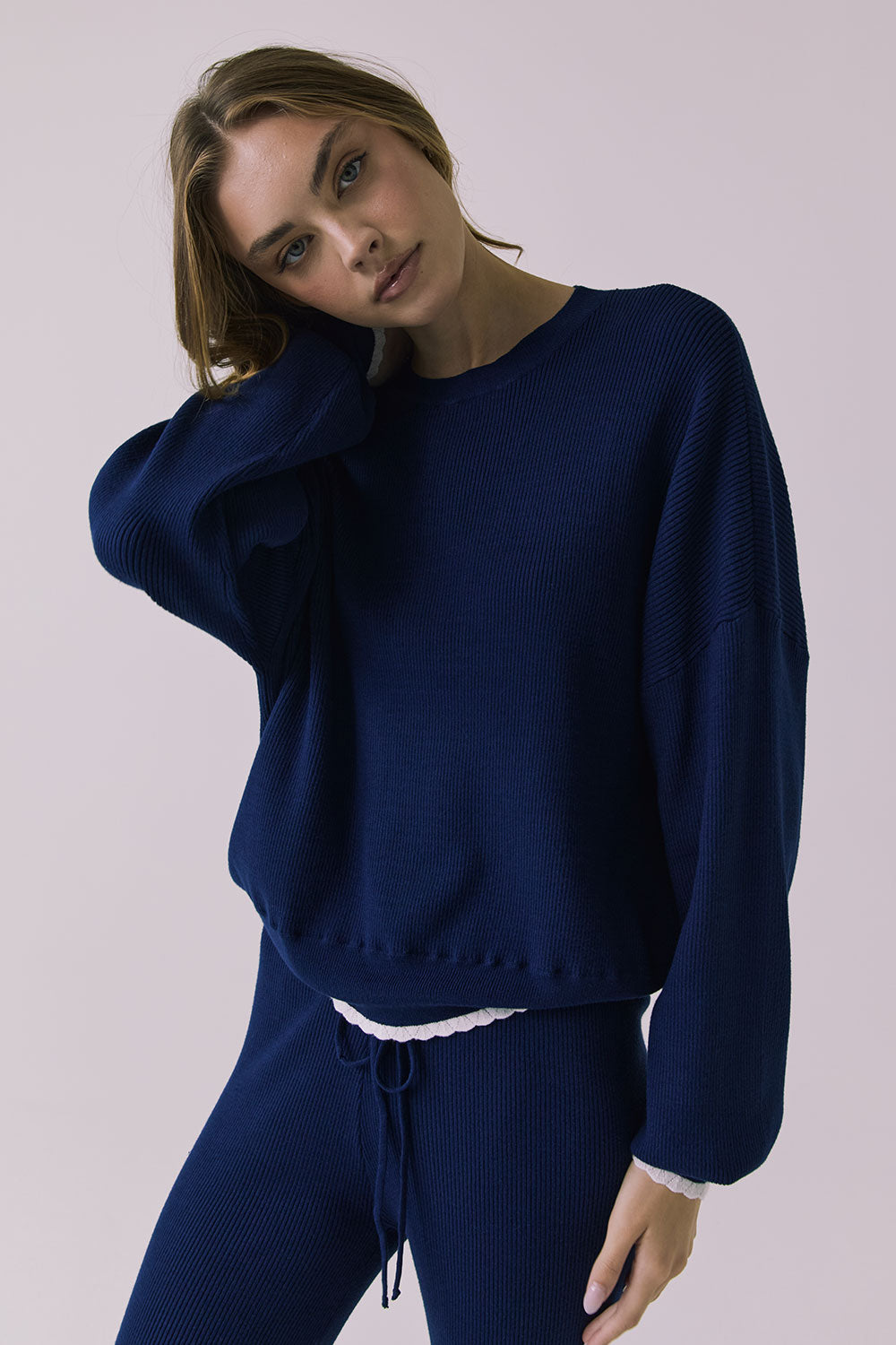 Three-quarter view of the Chaser Rhode Worn Blue Pullover showing the drape and wide sleeve shape