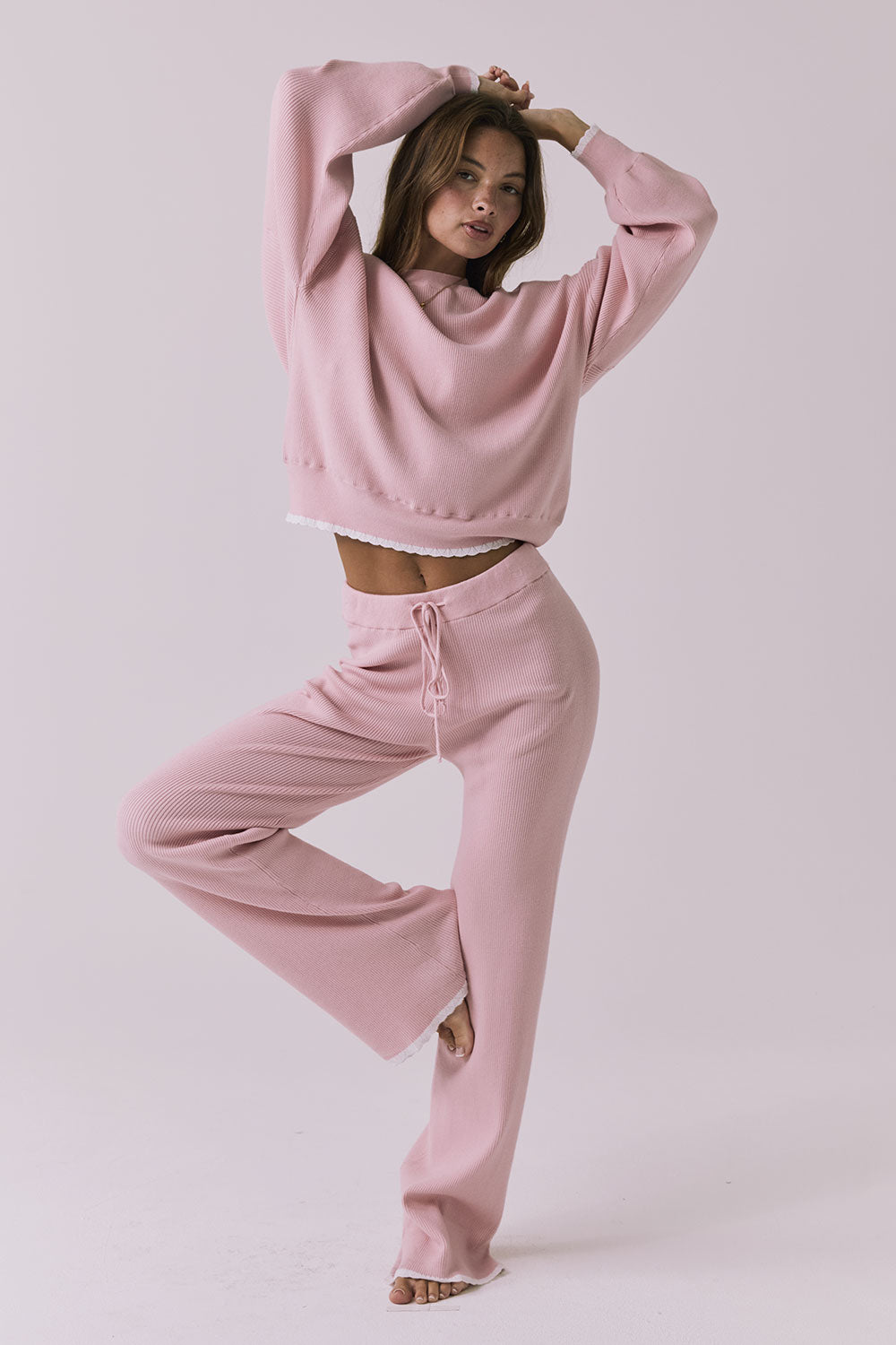 Full body view of the Chaser Sailor Pink Salt Joggers styled with the matching Rhode Pink Salt Pullover on a neutral studio background