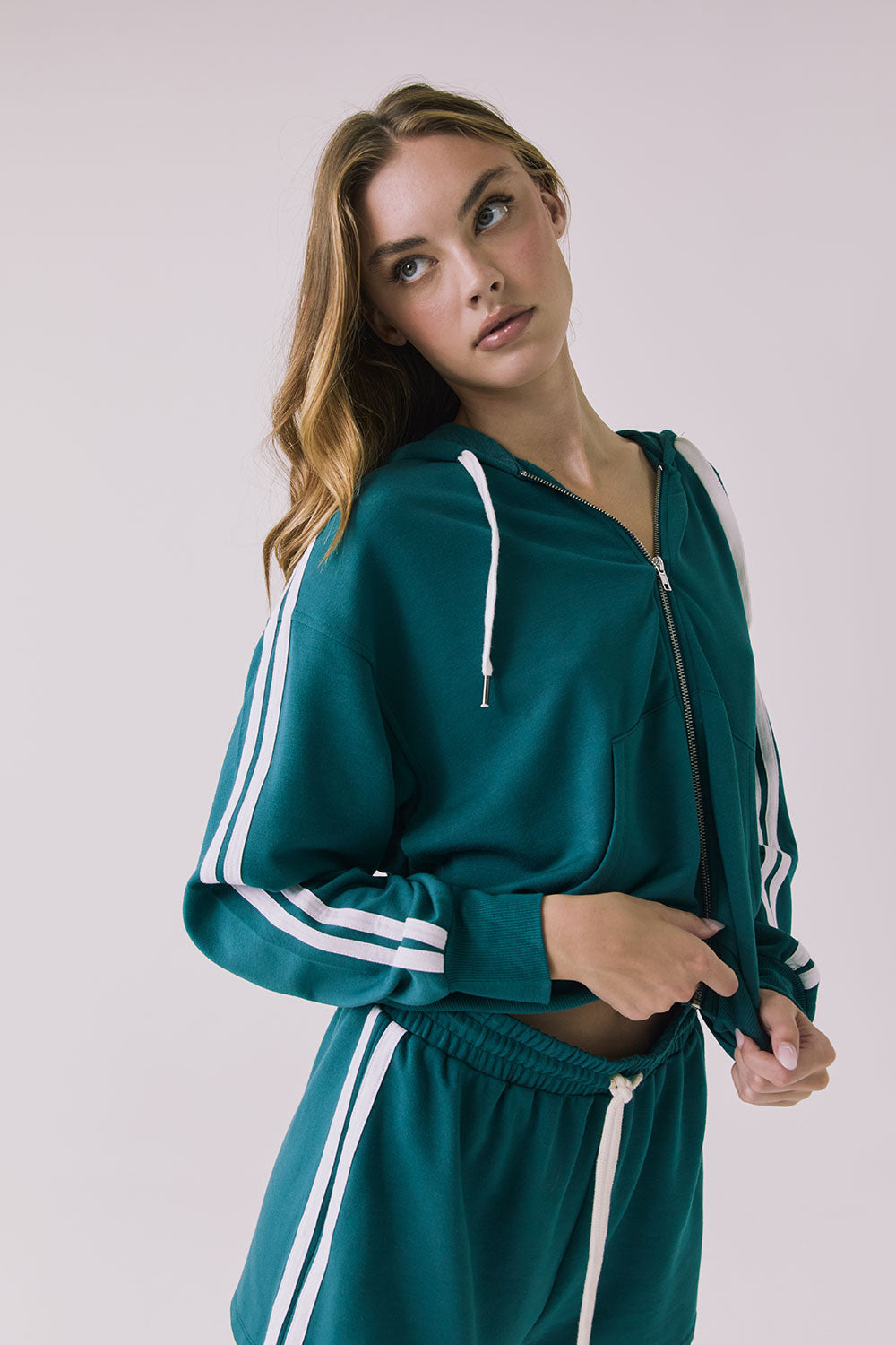Chaser Abilenee Teal Zip Up with White Stripes captured from a slight angle showcasing the contrast drawcords and sleeve stripes