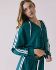 Chaser Abilenee Teal Zip Up with White Stripes captured from a slight angle showcasing the contrast drawcords and sleeve stripes