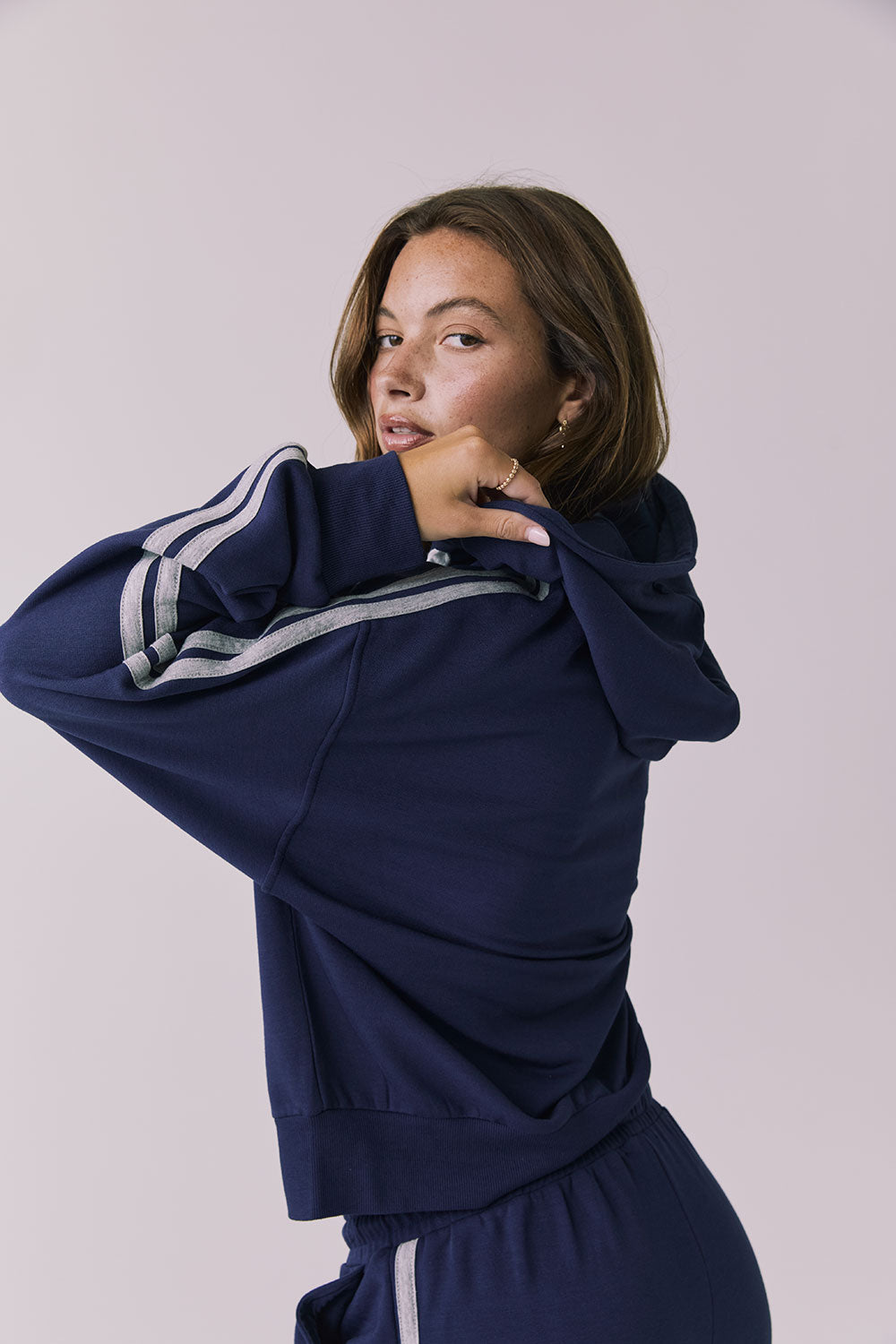 Chaser Abilene Sapphire Zip Up shown from a relaxed side angle highlighting the contrast stripe detail
