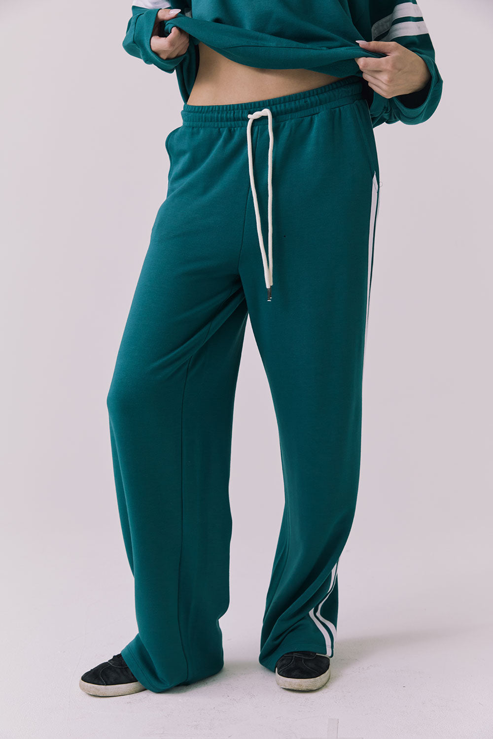 Saltwater Luxe Sandi Joggers in Teal with White side stripes close-up showing the soft fabric texture striped detailing and pocket construction