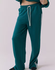 Saltwater Luxe Sandi Joggers in Teal with White side stripes close-up showing the soft fabric texture striped detailing and pocket construction