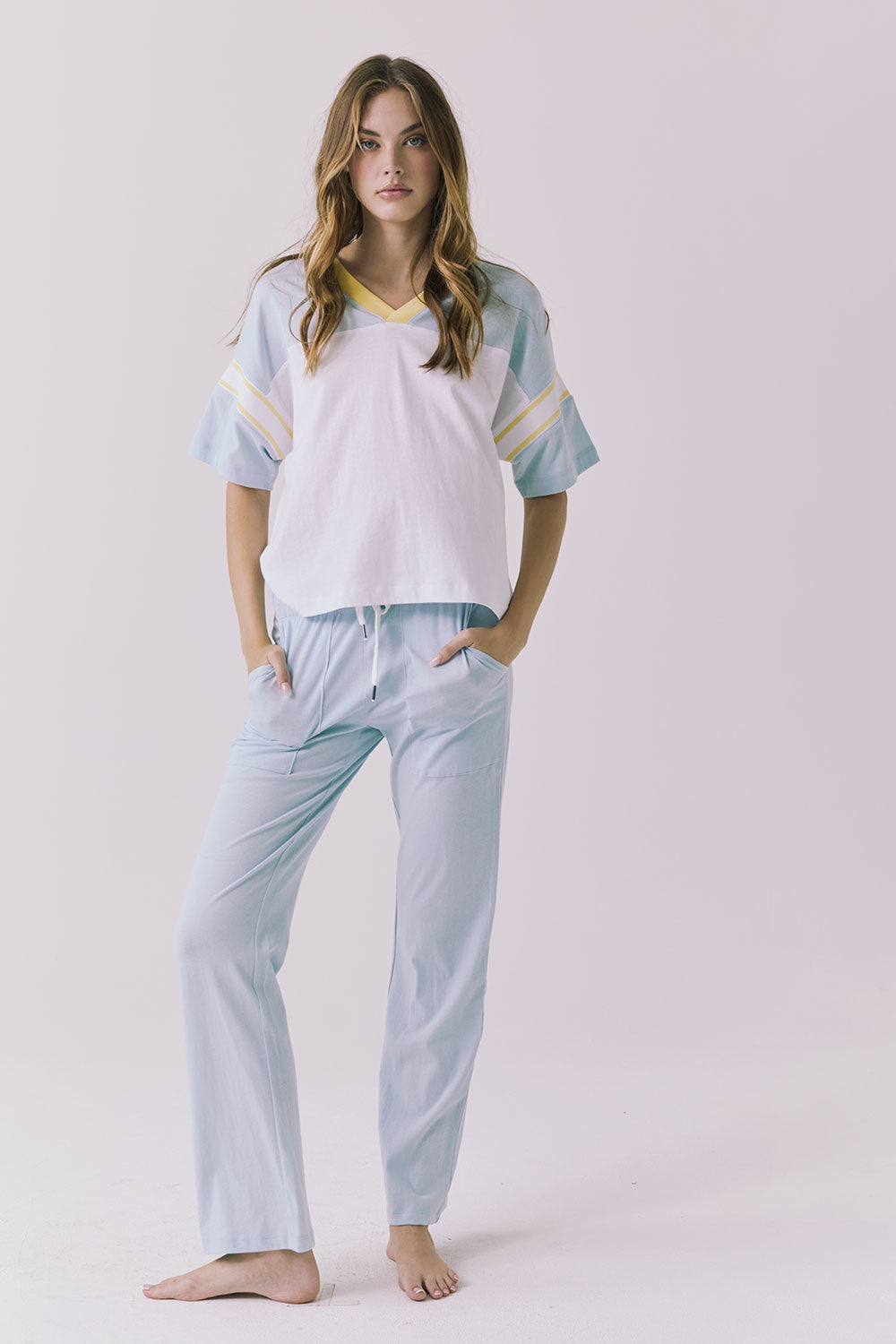 Chaser Palmer Tee in White with Mineral Butter trim styled solo with denim showcasing the relaxed sporty silhouette