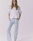 Chaser Palmer Tee in White with Mineral Butter trim styled solo with denim showcasing the relaxed sporty silhouette