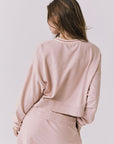 Back view of the Chaser Campbell Honey Peach Pullover highlighting the relaxed fit and soft vintage-wash fabric, paired with the Soleil Mini Skort
