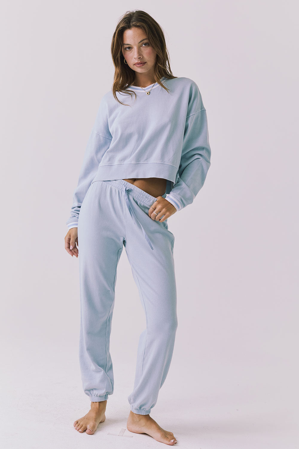 Chaser Campbell Bluebird Pullover full body angled view paired with matching Willa Joggers highlighting the cropped top and relaxed jogger fit