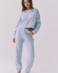 Chaser Campbell Bluebird Pullover full body angled view paired with matching Willa Joggers highlighting the cropped top and relaxed jogger fit