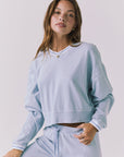 Chaser Campbell Bluebird Pullover shown from the front in soft bluebird with a relaxed cropped fit and ribbed hem styling