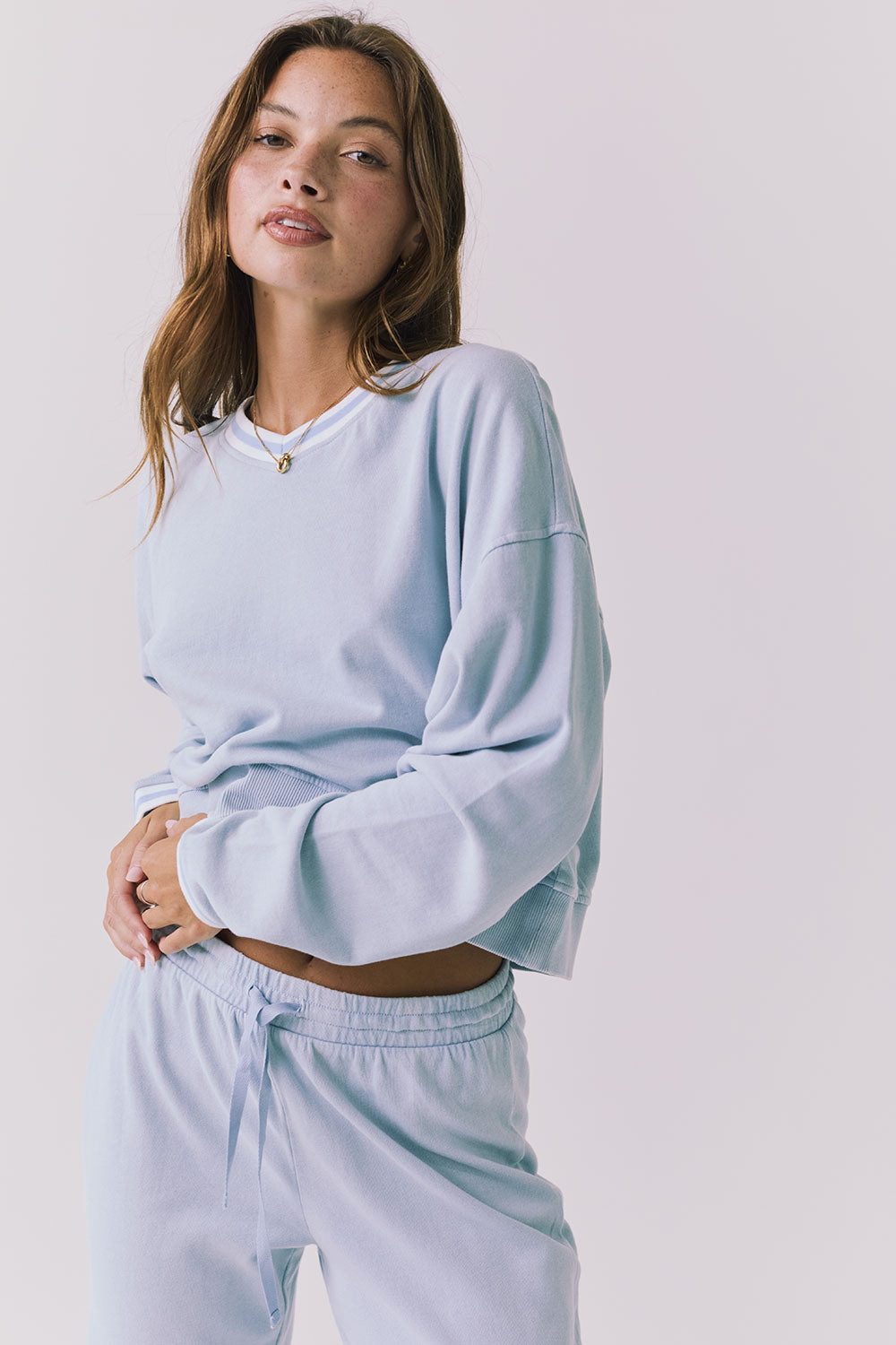 Chaser Campbell Bluebird Pullover detail view focusing on the ribbed cuffs, neckline trim, and soft brushed fabric texture