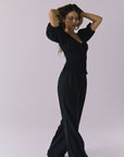 Chaser Abbie Black Blouse shown with matching Lee Trousers in a flowing side angle full body view while the model walks
