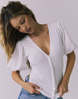 Front detail of the Abbie White Blouse with soft ruching and puff sleeves