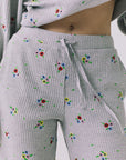 Close-up of the Chaser Brandy Heather Grey Ditsy Embroidery Crop Joggers highlighting the adjustable drawstring waist and embroidered floral details in the waffle knit fabric