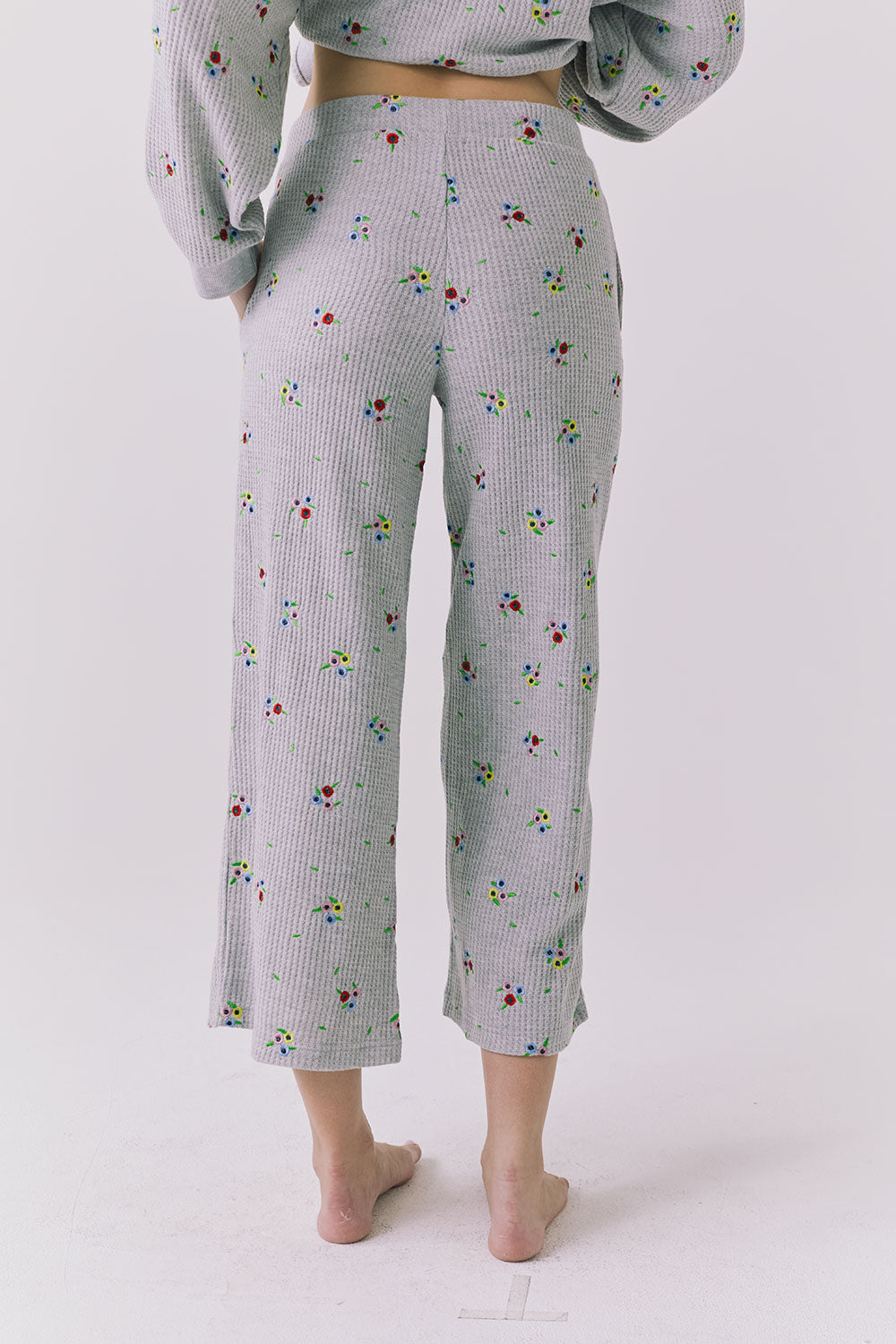 Back view of the Chaser Brandy Heather Grey Ditsy Embroidery Crop Joggers showing the cropped silhouette and allover embroidered pattern