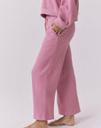 Side view of Chaser Brandy Crop Joggers in Sugar Magnolia highlighting the waffle knit fabric, side pocket detail, and relaxed lounge fit