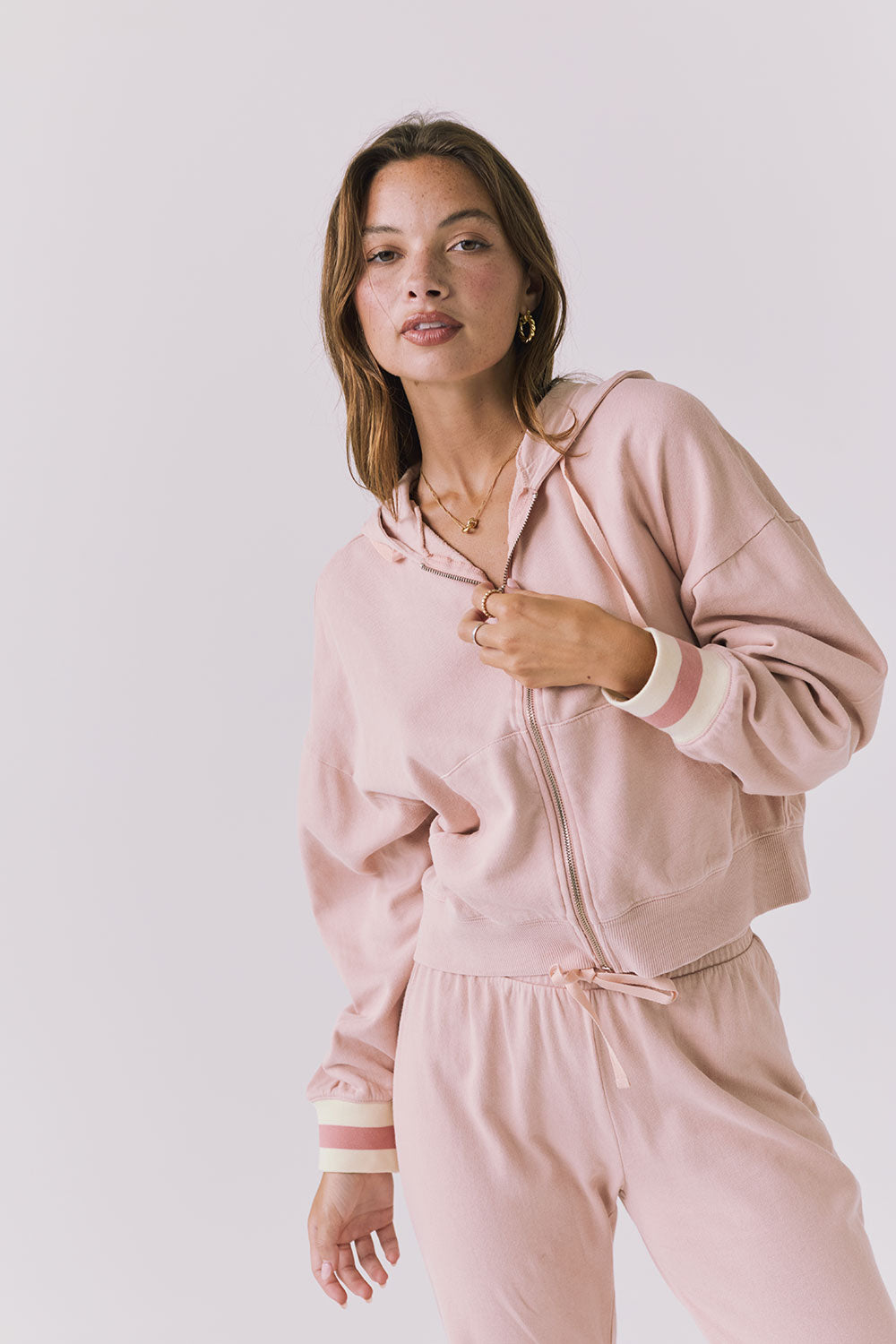 Close up of the Chaser Abilene Honey Peach Zip Up hoodie showing the zip front and striped cuff detailing