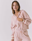 Close up of the Chaser Abilene Honey Peach Zip Up hoodie showing the zip front and striped cuff detailing