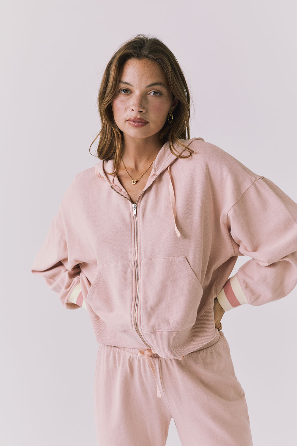 Chaser Abilene Honey Peach Zip Up hoodie in soft pastel peach shown in a clean studio setting with relaxed dropped shoulders and striped cuffs