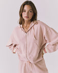 Chaser Abilene Honey Peach Zip Up hoodie in soft pastel peach shown in a clean studio setting with relaxed dropped shoulders and striped cuffs