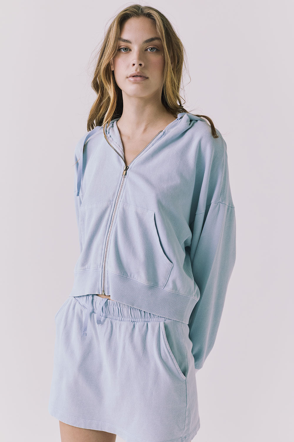 Chaser Abilene Blue Bird Zip Up in a cropped front angle showcasing the zipper and pocket details